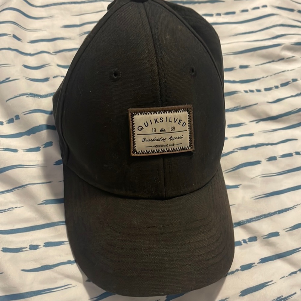 Black hat with a logo in middle